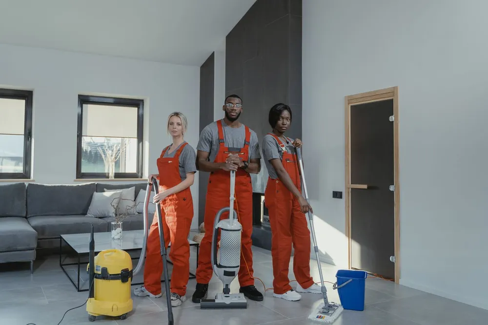 Professional cleaning team with equipment inside a client home.